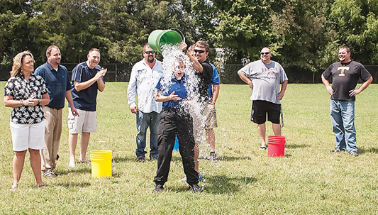 Photo by Brandon Hicks Deputy Michele Meade, the school resource officer for Hunter Elementary School, takes the Ice Bucket Challenge Friday afternoon at the school. She was one of 10 individuals to participate in the challenge.