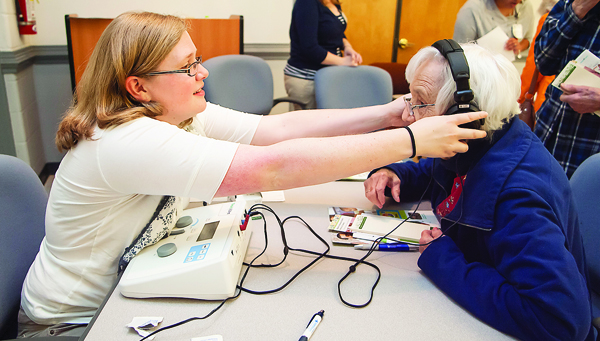 Photo by Brandon Hicks Erin Dula with East Tennessee State Univeristy Audiology tests Dot Oaks' hearing.