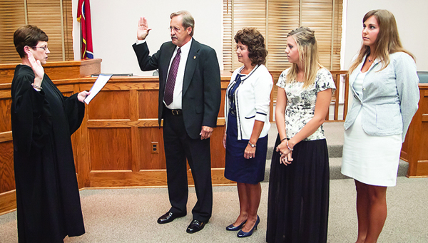 Photo by Brandon Hicks Newly elected Sheriff Dexter Lunceford, second from left, is administered his oath of office by Circuit Court Judge Jean Stanley on Friday afternoon as his wife and daughters look on.
