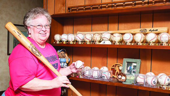 Photo by Brandon Hicks Paula Bishop shows off her collection of Twins memorabilia, which includes autographed baseballs from local players. Twins Manager Ray Smith has given Bishop a baseball autographed by Twins players each year since 1988.