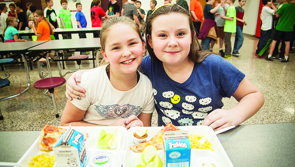 Photos by Brandon Hicks Christina Melton, left, and Faith Shell enjoy lunch together at Happy Valley Elementary School.