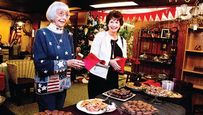 Photos by Bryce Phillips Above, Elizabethton residents Carleen Norton, right, and Earlene Holtsclaw enjoy the large selection of finger foods at the Duck Landing Antique Mall during the downtown Elizabethton’s Christmas Open House. 