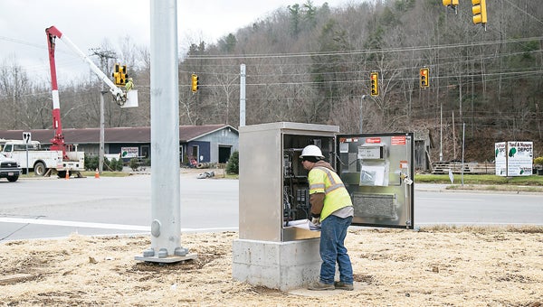 Photo by Brandon Hicks Stevie Hall and Alex Nida of Elliot Electrical Contractors work together on the timing and operation of the new traffic light at the intersection of Highway 19E and Highway 321 in Hampton.