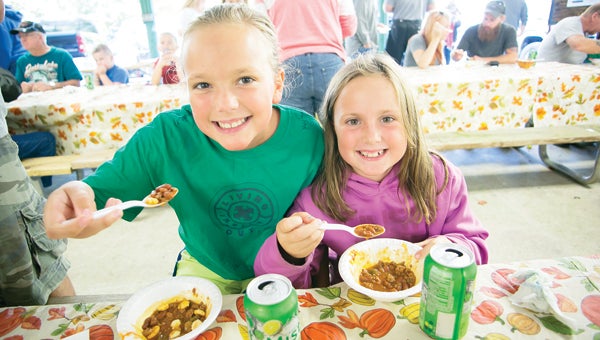 Photo by Brandon Hicks Kaylee and Payton Long enjoy a bowl of chili at the Roan Mountian State Park chili cookoff.