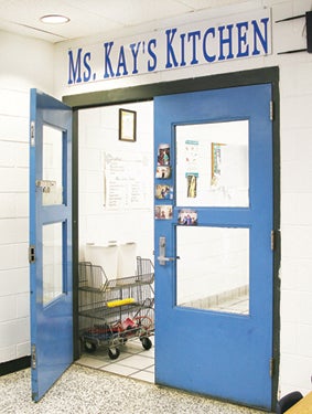 Star Photo/Abby Morris-Frye  A sign above the door proudly proclaims that Hampton Elementary School is home to Ms. Kay's Kitchen.
