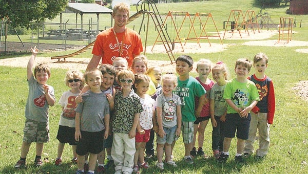 Star Photo/Abby Morris-Frye  Central Elementary physical education teacher Michael Lunsford, at rear, stands with a group of Head Start students on the school's playground. The school recently received a grant for $10,000 in new physical education equipment.