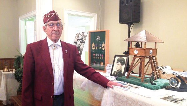 Star Photo/Lynn Richardson World War II veteran George Hatcher shares his story and memorabilia with the Elizabethton Rotary Club on Wednesday.