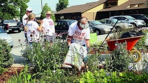 Star Photo/Ashley Rader Sherri Hyder adds mulch to a flower bed outside the Elizabethton Senior Citizens Center for the United Way's Week of Caring.