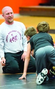 Star Photo/Bryce Phillips     Assistant Travis Pennell helps out duirng Tuesday's second annual Cyclones Wrestling Camp.