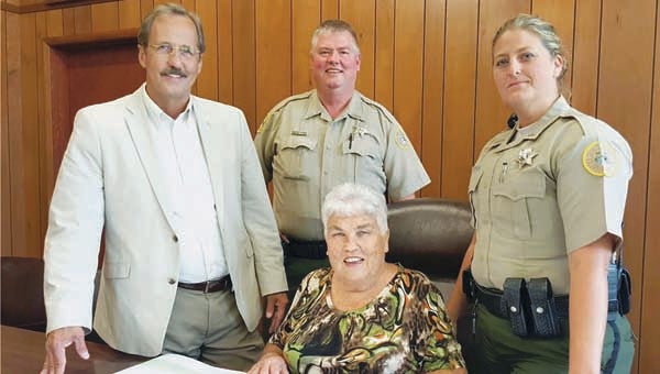 Star Photo/Holly Davidson Carter County Sheriff Dexter Lunceford, Deputy Steve Stevenson, Deputy Amanda Little and Watauga City Manager Hattie Ruth Skeans, seated, discuss the contract between the town and the Sheriff's Department for police services.