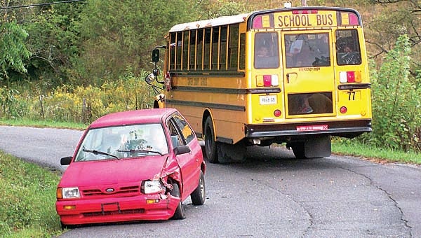 Star Photo/Abby Morris-Frye  No children were injured Thursday afternoon when a small Ford crossed over the center of the road and struck a Carter County School bus on Willow Springs Road.