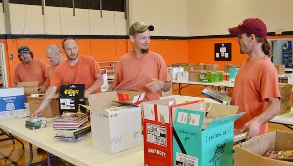 Star Photo/Rebekah Price Dallas Hartly, Quincy Roark, Marcus Largent, James Harris and Michael Woodby are Carter County inmates who have helped throughout the year with book collection and this week, with the transportation and setup of all the books for the book sale.
