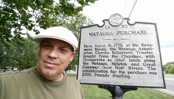 Local genealogist Steve Blevins stands next to a state historical marker which he has learned has historic significance to his family's history