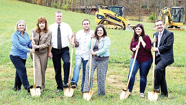 Contributed Photo Program officials gathered with homeowners to celebrate groundbreaking for news homes in the Patriots Place development.