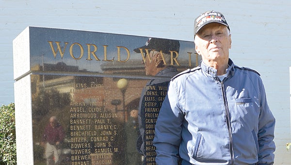 Star Photo/Rebekah Price   Earl Ellis stands proud beside the black granite war memorial.