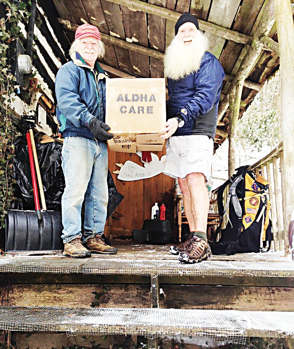 Contributed Photo  Bob Peoples, owner of Kincora Hostel in Hampton, receives a care package from ALDHA Care Coordinator Jim Chambers to help supply his low cost hostel through peak season.