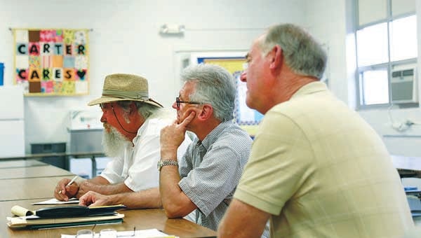 Star File Photo  Carter County Commissioners Willie Campbell, Dr. Robert Acuff and Buford Peters listen to a constituent during a town hall meeting in August. The three commissioners will hold another town hall meeting for the First District this Saturday morning at Unaka High School.