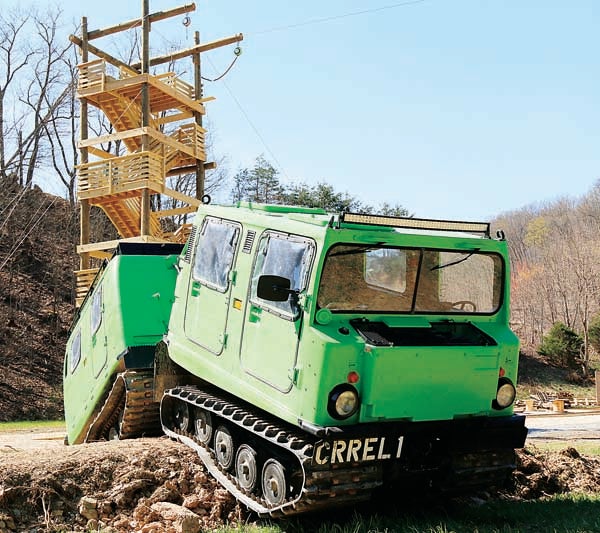 Star Photo/Bryce Phillips  Off the Grid Mountain Adventures' Hagglund, a Swedish military vehicle, sets parked in front of a 60-foot tower chocked full of thrills. This coming Monday, the outdoors adventure park, located off of Highway 19E in Elizabethton, will be open for business.