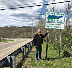 Contributed Photo  Edward Jordan stands proud beside the new Carter County Proud! Adopt a Highway sign.