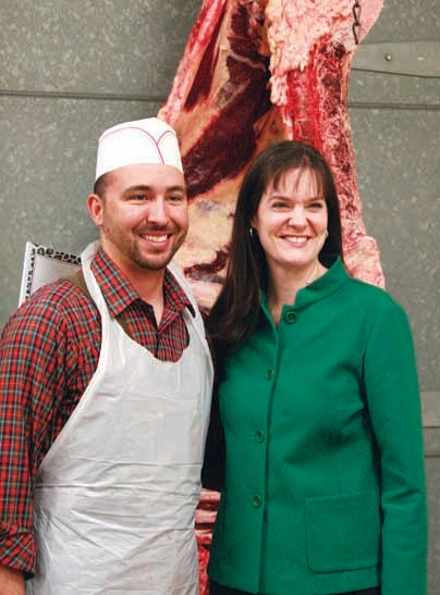 Star Photo/Abby Morris-Frye  Tennessee Commissioner of Education Candice McQueen took a break from her tour of Unaka High School to pose with agriculture teacher Josh Armentrout, whose classes include the school's meat science. McQueen said she had never seen another program like the meat cutting class at UHS.