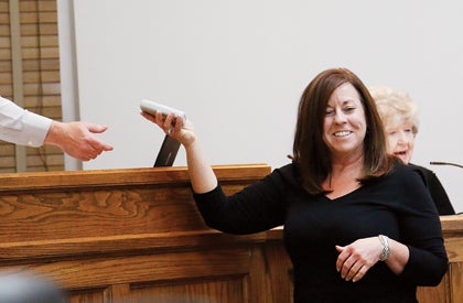 Star Photo/Rebekah Price Commissioner Kelly Collins accepts a remote to vote after taking her oath of office and then took her seat as a new Carter County Commissioner.