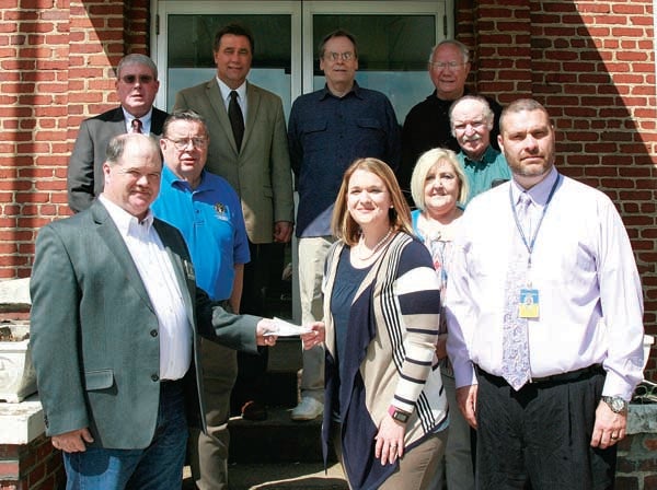 Star Photo/Abby Morris-Frye  Members of the Knights of Columbus from St. Elizabeth Catholic Church presented school officials with a donation of $751 on Monday. The funds will be used to assist the special education program at Hunter Elementary.