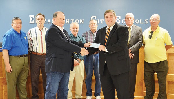 Star Photo/Rebekah Price  Deputy Grand Knight Jimmy Townsend with the Knights of Columbus presents Director of Elizabehtton City School Dr. Corey Gardenhour a $1,000 check to benefit special education programs in the city schools. (Pictured left to right) Tom Manning, Hugh Buckles, Chairman Bob Peoples, Mike Hupko, Treasurer Richard Barker, and Grand Knight Jim Stapleton