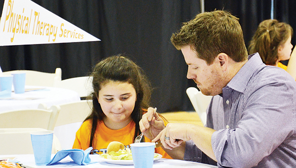 Star Photo/Rebekah Price The Steak'N'Burger is an event held by Boys and Girls Clubs across America in order to raise support for the clubs, but also to make kids feel special. At the luncheon, attendees eat burgers and the club kids eat steaks, and many get help cutting their steaks from their new friends at their tables.