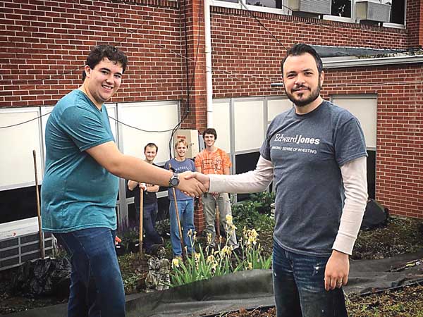 Boy Scout Jordan Byrd and Financial Adviser Thomas Davis celebrate a job well done beautifying Valley Forge and completing Byrd's Eagle Scout project.