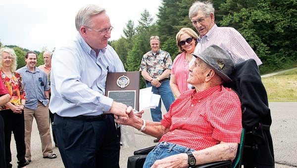 Star Photo/Bryce Phillips  Carter County Mayor Leon Humphrey presents Roan Mountain's Durward Julian, who recently turned 100 years old, a plaque for his life-long contributions to the Roan Mountain community.