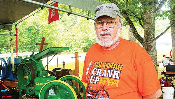 Star Photo/Curtis Carden  ETAEA president Dave Keplinger stands with his John Deere engine during Saturday’s event.