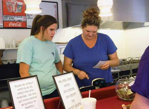 Star Photo/Victoria Perkins  Missy Garland, left, and her daughter, Megan, wait on a customer at Missy's Waterwheel Cafe.