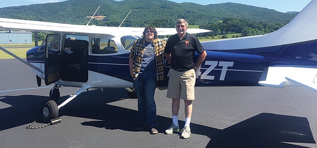 Contributed Photo Seth Simerly, left, poses with Elizabethton High School instructor Dan Mills, after earning solo wings. Simerly is the fifth student from the school to earn the accomplishment.